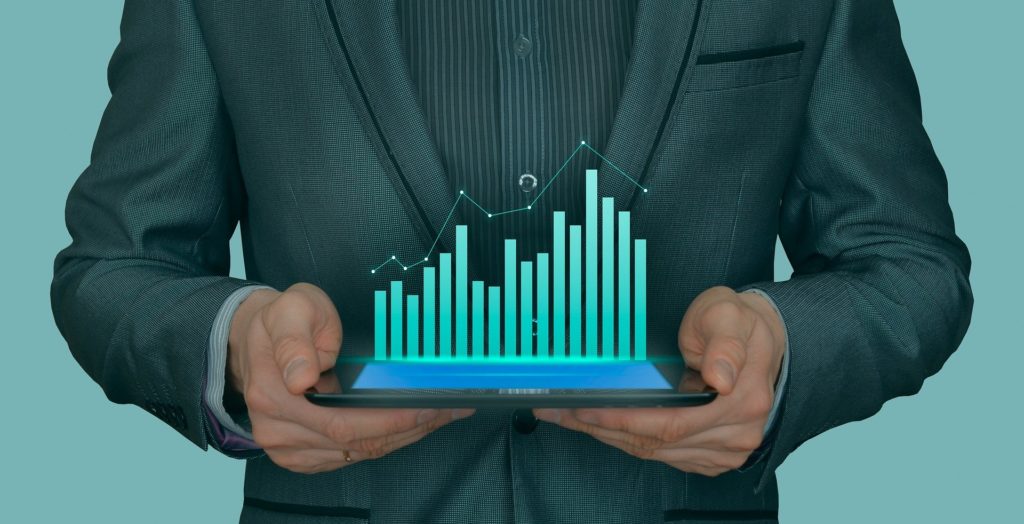 A man holding an investment chart